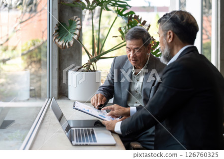 Elderly man discussing business strategies with colleague 126760325
