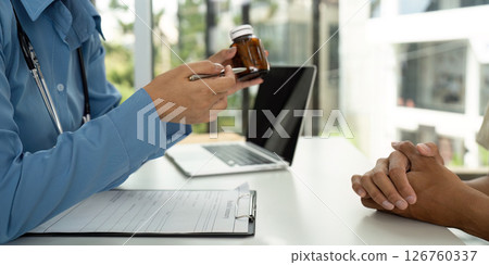 Health and Wellness: Doctor Reviewing Medication with Patient 126760337