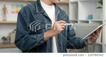 Digital Design. Young designer selecting colors on tablet in creative workspace. Digital Design. Young designer selecting colors on tablet in creative workspace. 126760342