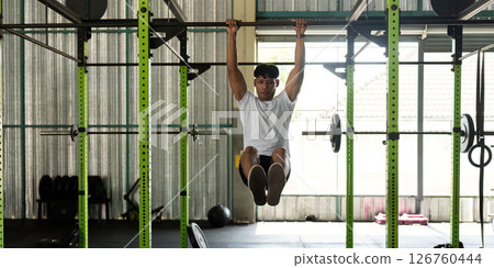 Fitness Training: Young Man Performing Muscle-Up Exercise in Gym Fitness Training: Young Man Performing Muscle-Up Exercise in Gym 126760444