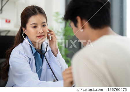 Health and Wellness. Doctor using a stethoscope to assess a patient's health. 126760473