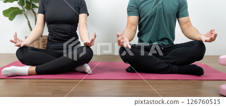 Wellness and Couple. Partners meditating together, enhancing their emotional and physical well-being. Wellness and Couple. Partners meditating together, enhancing their emotional and physical well-being. 126760515