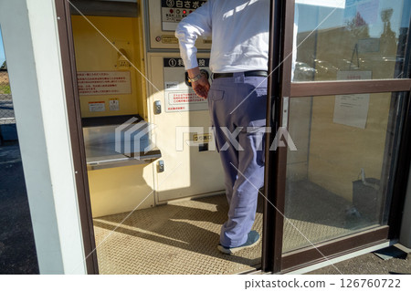 Polishing rice with a coin-operated rice polishing machine Polishing rice with a coin-operated rice polishing machine 126760722