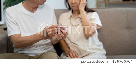 Wellness and Care. Elderly couple monitoring health together at home. Wellness and Care. Elderly couple monitoring health together at home. 126760764