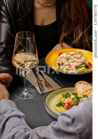 Couple enjoying romantic dinner with wine and gourmet food 126760778