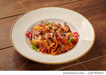 Pappardelle pasta with beef and vegetables on wooden table 126760954