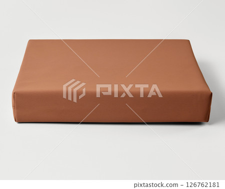Modern light brown yoga bolster resting on white surface 126762181