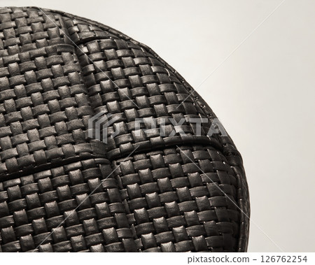 Close-up of black woven leather surface showing intricate detail and texture 126762254