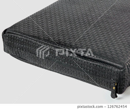 Close-up of black leather briefcase showing intricate woven pattern 126762454