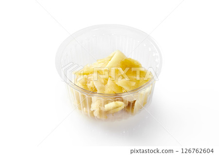 Pickled ginger slices in plastic container on white background Pickled ginger slices in plastic container on white background 126762604