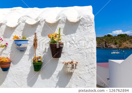 Menorca Es Grau white house flower pots detail in Balearic Menorca Es Grau white house flower pots detail in Balearic 126762894