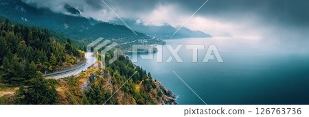 Scenic road along mountain coast with forest and sea in aerial view 126763736