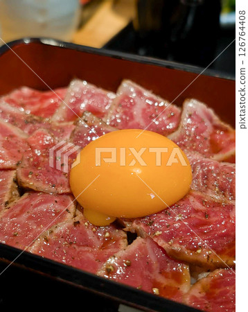 Marbled Wagyu beef tataki rice bowl topped with egg yolk 126764408
