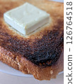Breakfast of burnt toast with butter 126764518