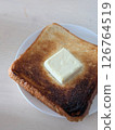 Breakfast of burnt toast with butter 126764519