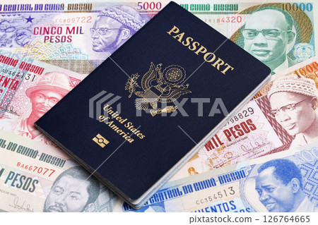 American passport on a Guinea Bissau money American passport on a Guinea Bissau money 126764665
