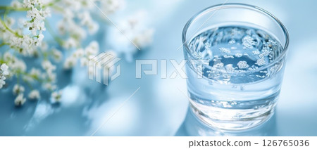 Sparkling water with flowers nearby Sparkling water with flowers nearby 126765036