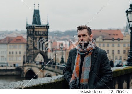 Man in scarf stands at historic Czech bridge 126765092