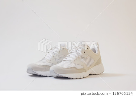 White athletic sneakers on a plain background 126765134