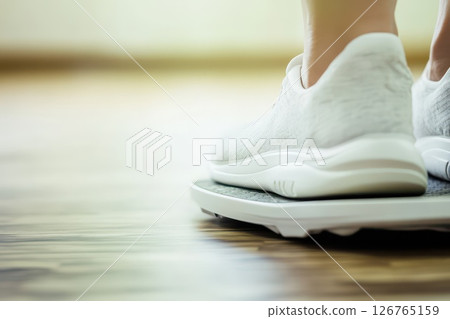 Weight measurement with athletic shoes on a scale 126765159