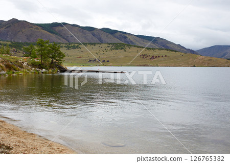 Rocky shore of a lake on a cloudy summer day 126765382