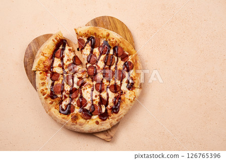 Delicious sausage pizza with a generous layer of cheese and juicy barbecue sauce, perfect for any celebration 126765396