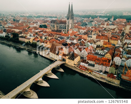 Regensburg showcases historic architecture along the Danube River at sunrise on a misty morning 126765548