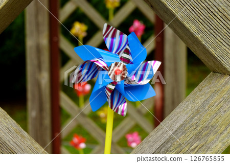 Windmill peeking through a wooden frame 126765855