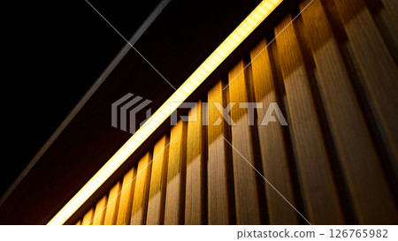 Soft light highlights textured wood paneling, creating a warm atmosphere 126765982