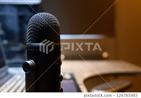 Close-up of a microphone in a recording studio while audio is being captured Close-up of a microphone in a recording studio while audio is being captured 126765985