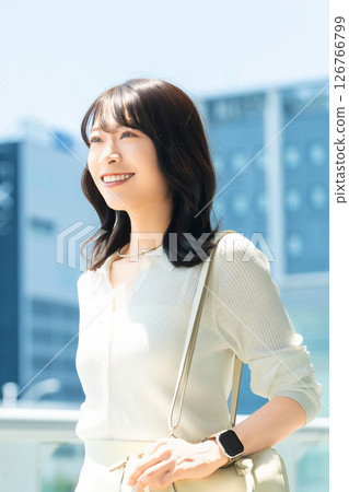 Woman/businesswoman walking in an office district 126766799
