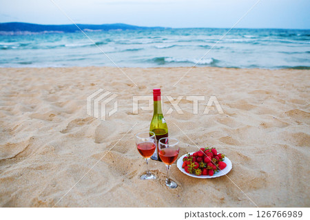 beautiful picnic on a sandy beach-wine and strawberry 126766989