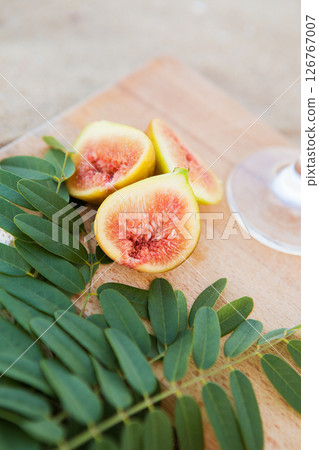 cut figs on a wooden board near the sea cut figs on a wooden board near the sea 126767007