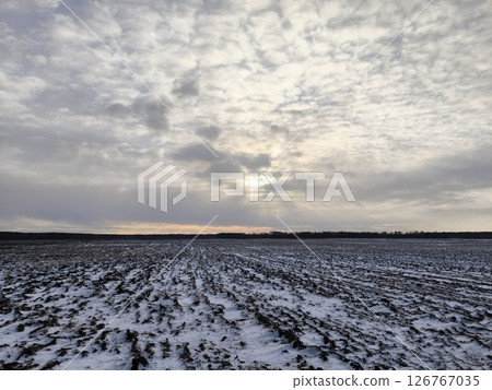 Snowy plowed field. plowed field covered with snow after a snowfall, an agricultural field in winter Snowy plowed field. plowed field covered with snow after a snowfall, an agricultural field in winter 126767035