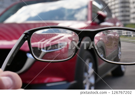 Dirty glasses lenses that show a blurred car detailed stock photo Dirty glasses lenses that show a blurred car detailed stock photo 126767202