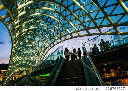 Silhouettes on Pedestrian bridge in park Rike  (over river Kura)  -summer coming 126768527