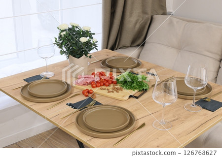 An Elegant Dining Setup Featuring Fresh Ingredients Amidst a Cozy and Warm Ambiance 126768627