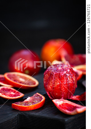 Fresh ripe red blood oranges (sicilian) on dark background Fresh ripe red blood oranges (sicilian) on dark background 126768721