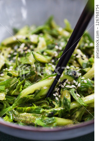 Asian style chuka wakame seaweed or sea mustard, cucumbers, green lettuce and sesame seeds fresh salad 126768754