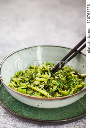 Asian style chuka wakame seaweed or sea mustard, cucumbers, green lettuce and sesame seeds fresh salad 126768758