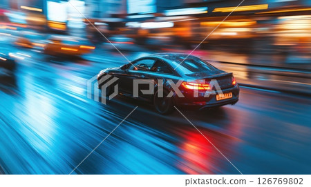 Fast car on rainy city street at night with blurred background 126769802