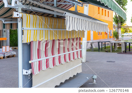 Colorful striped awnings displayed outdoors showcasing various patterns and colors 126770146