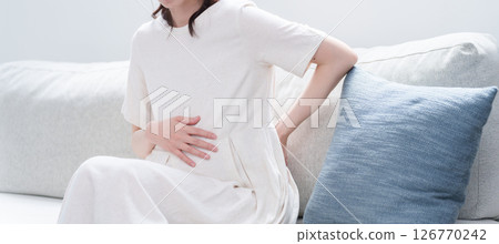 Young pregnant woman with back pain Young pregnant woman with back pain 126770242