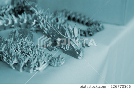 Creative multi-colored object printed on 3D printer from melted colored plastic. Artistic model printed by 3D printer from multi-colored plastic. Modern additive 3d printing technologies. Blue color 126770566