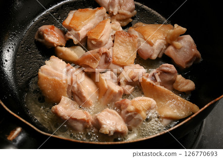 Grilling chicken thighs 126770693