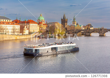 Charles Bridge and boat on Vltava River, Prague, Czech Republic 126771308