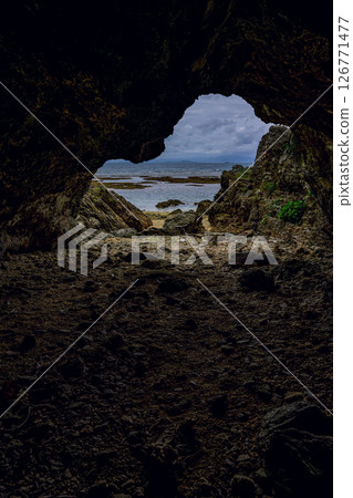 Mysterious sea view of Kannonzaki, Ishigaki Island, seen from inside a cave - a power spot Mysterious sea view of Kannonzaki, Ishigaki Island, seen from inside a cave - a power spot 126771477