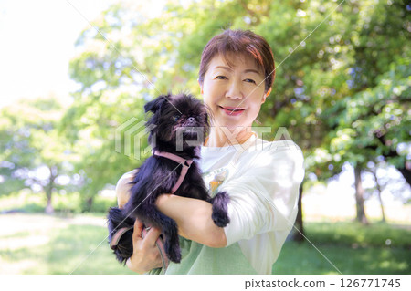 Japanese woman holding her pet dog Japanese woman holding her pet dog 126771745
