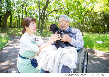 Pet therapy: A dog, a happy elderly man and his helper Pet therapy: A dog, a happy elderly man and his helper 126771978