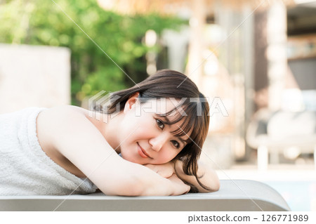 A woman receiving a massage at a tropical spa, beauty salon, or esthetic salon 126771989